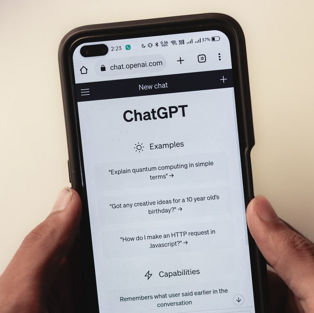 a person holding a cell phone with a chat app on the screen